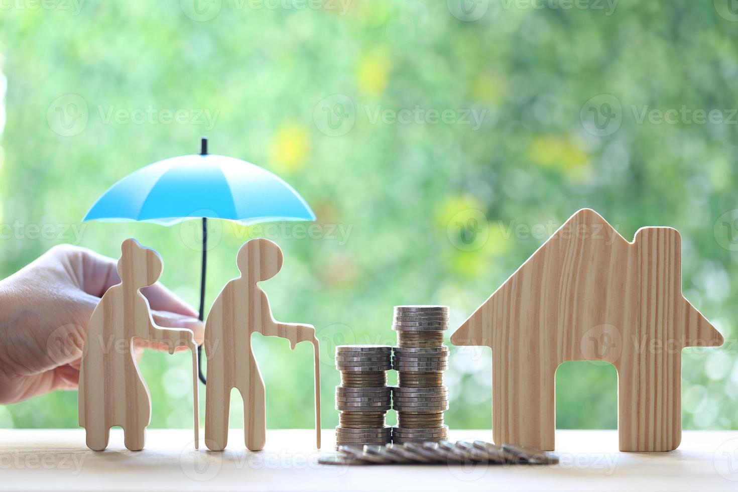 Mutual fund,Love couple senior and model house with stack of coins money on natural green background, Save money for prepare in future and pension retirement concept photo