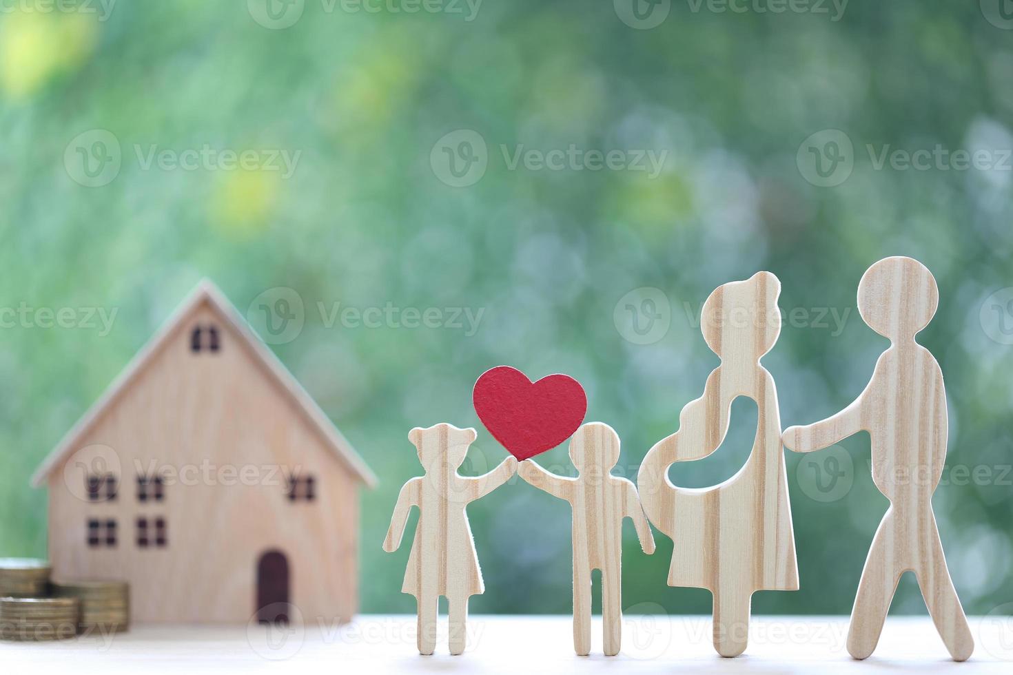 Model family with model house and stack of coins money on natural green background,Save money for prepare in future and family finance concept photo