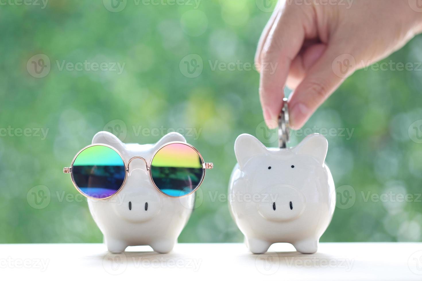 Saving for prepare in future and Business investment concept, Woman hand putting a coin into piggy bank on green background, Finance photo