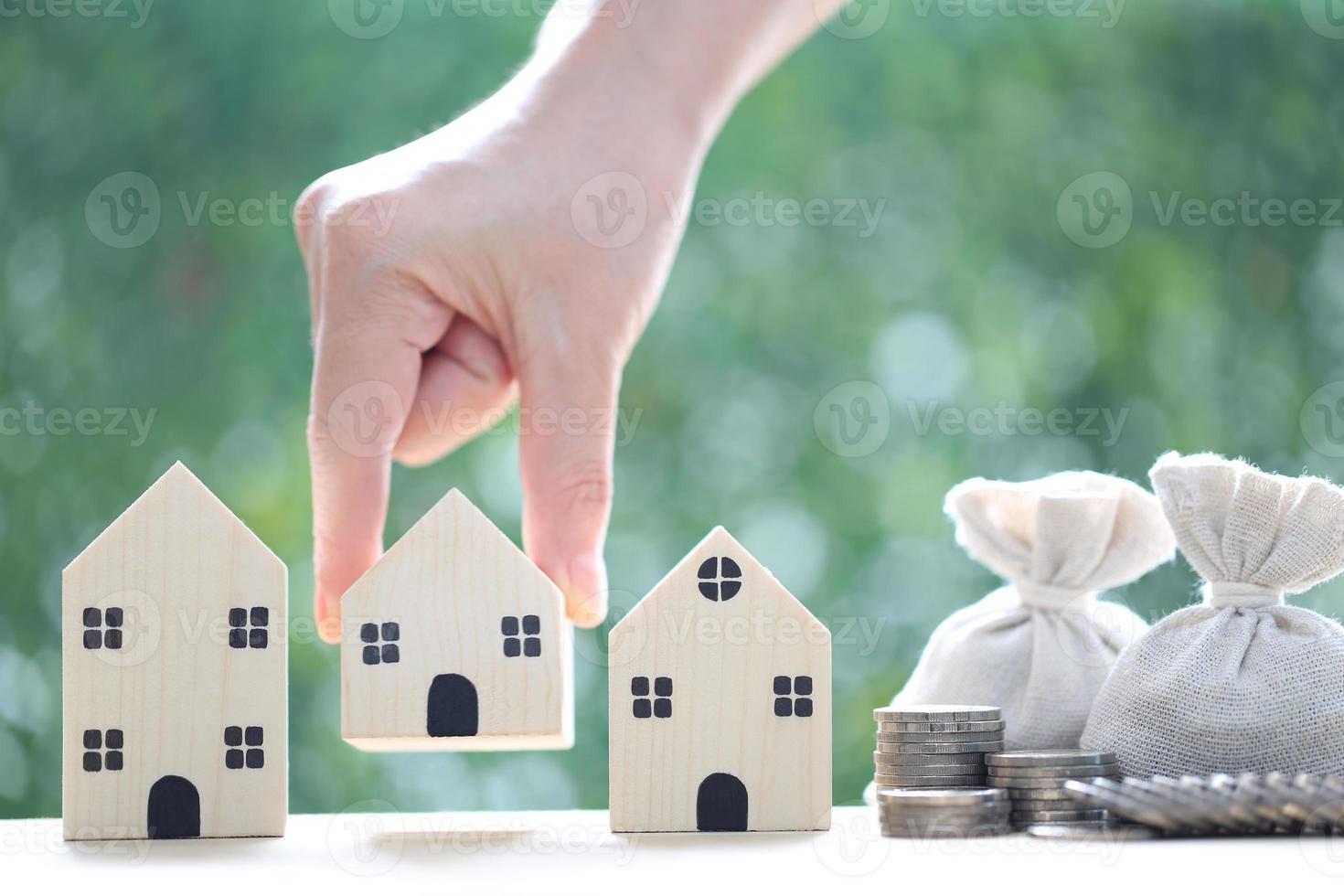 Finance, Model house with and money bag on natural green background,Business investment and Save money for prepare in future concept,Inflation photo