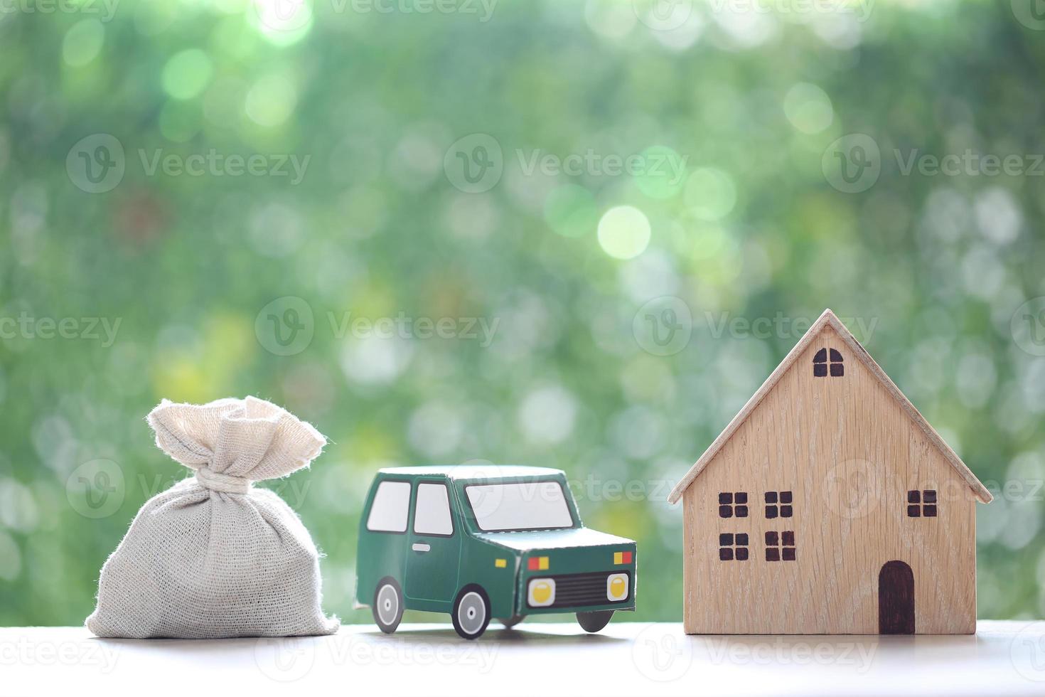 Finance, Model house with the car and money bag on natural green background,Business investment and save money for prepare in future concept,Inflation photo