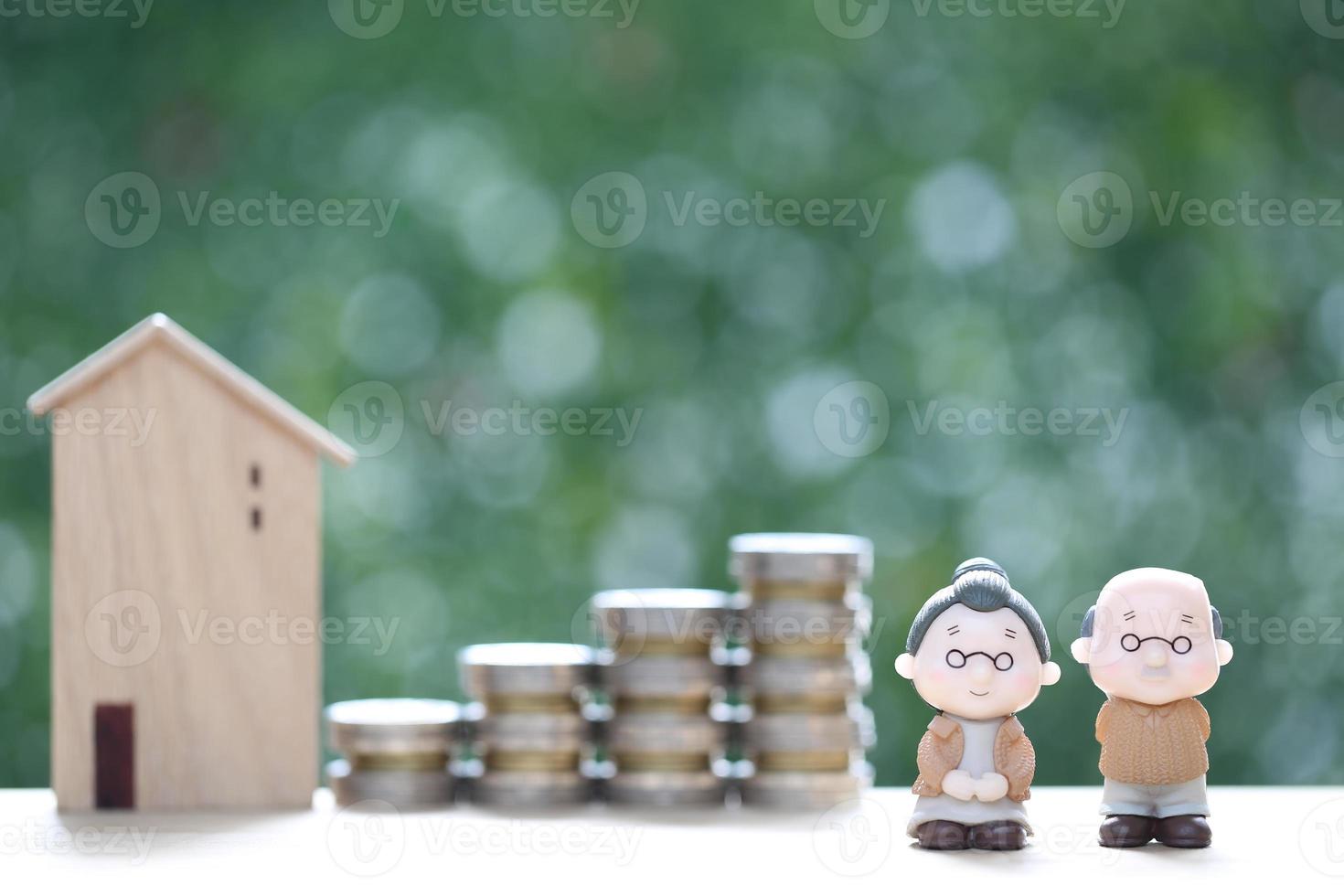 Mutual fund,Love couple senior and model house with stack of coins money on natural green background, Save money for prepare in future and pension retirement concept photo