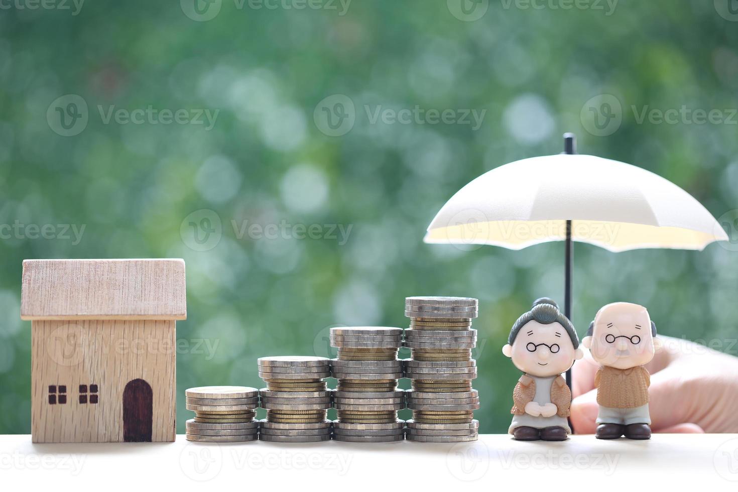 Mutual fund,Love couple senior and model house with stack of coins money on natural green background, Save money for prepare in future and pension retirement concept photo