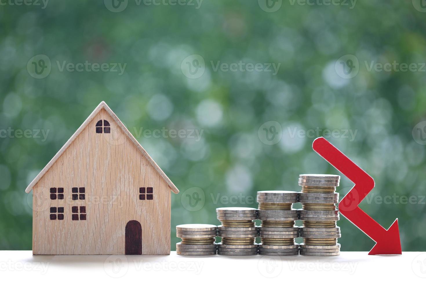 Finance, Model house with stack of coin money and red arrow graph on natural green background,Business investment and Save money for prepare in future concept,Inflation photo