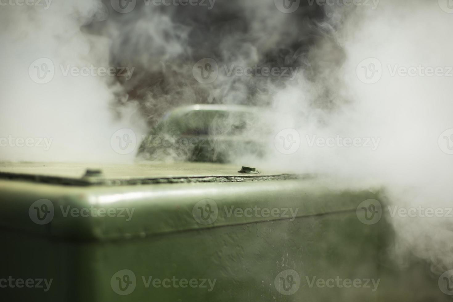 Military field kitchen. Steam from kitchen outside. Smoke from burning. Cooking in army is in detail. photo