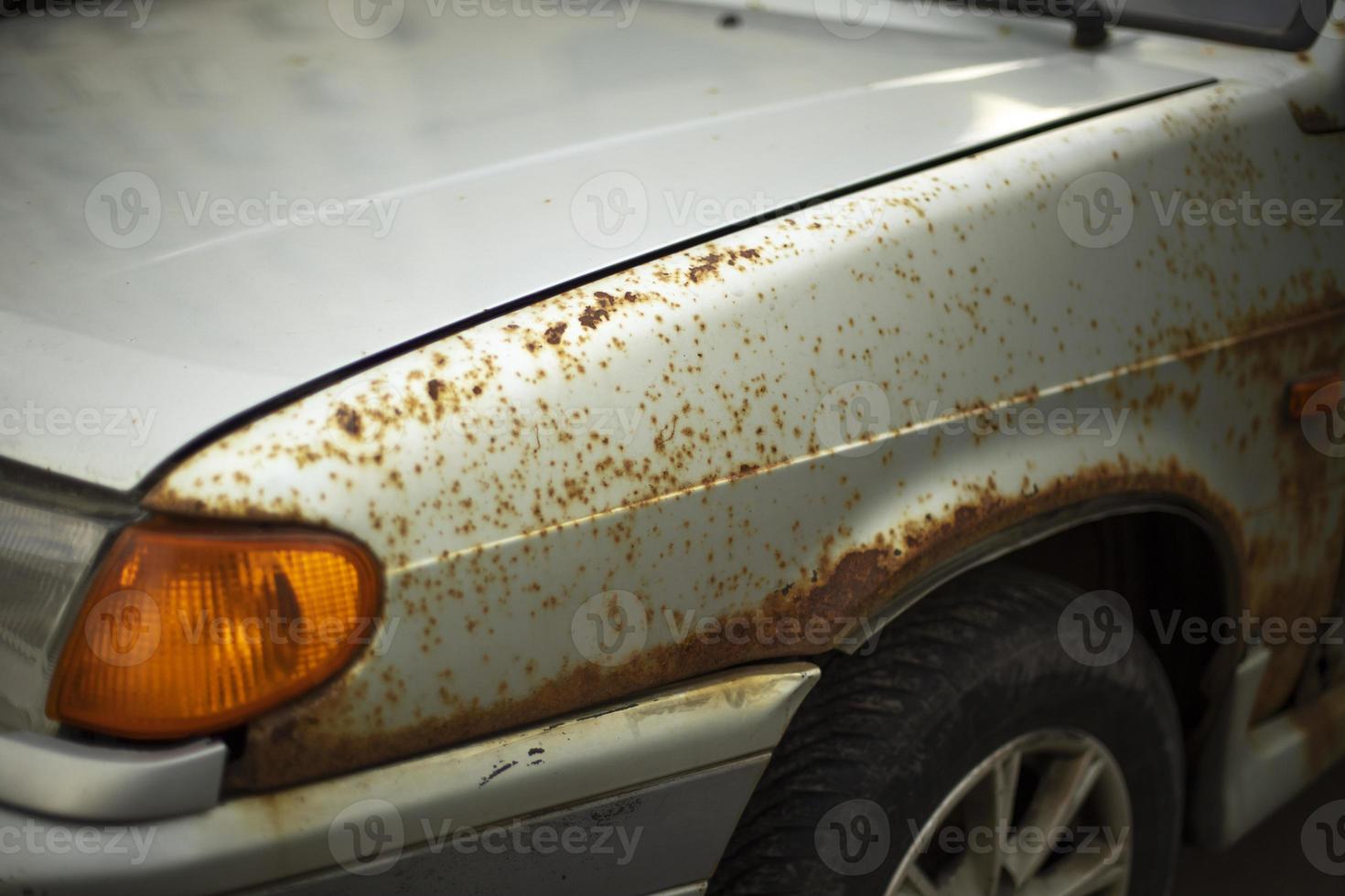 Rusty car. Rust on metal. Turn signal of car. photo