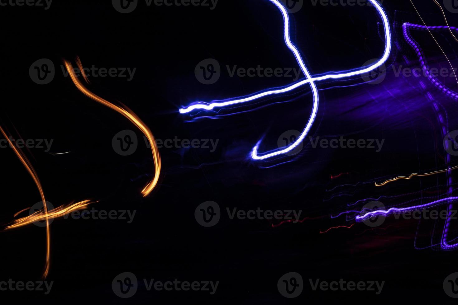 Lights in dark. Movement of glowing lines. Details of light music. photo