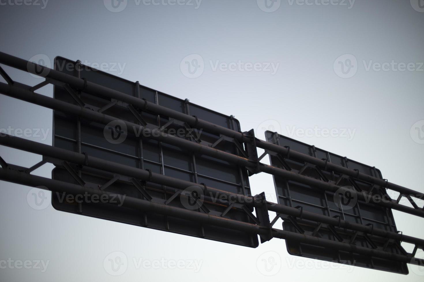 Metal construction over road. Shield with sign removed from behind. photo