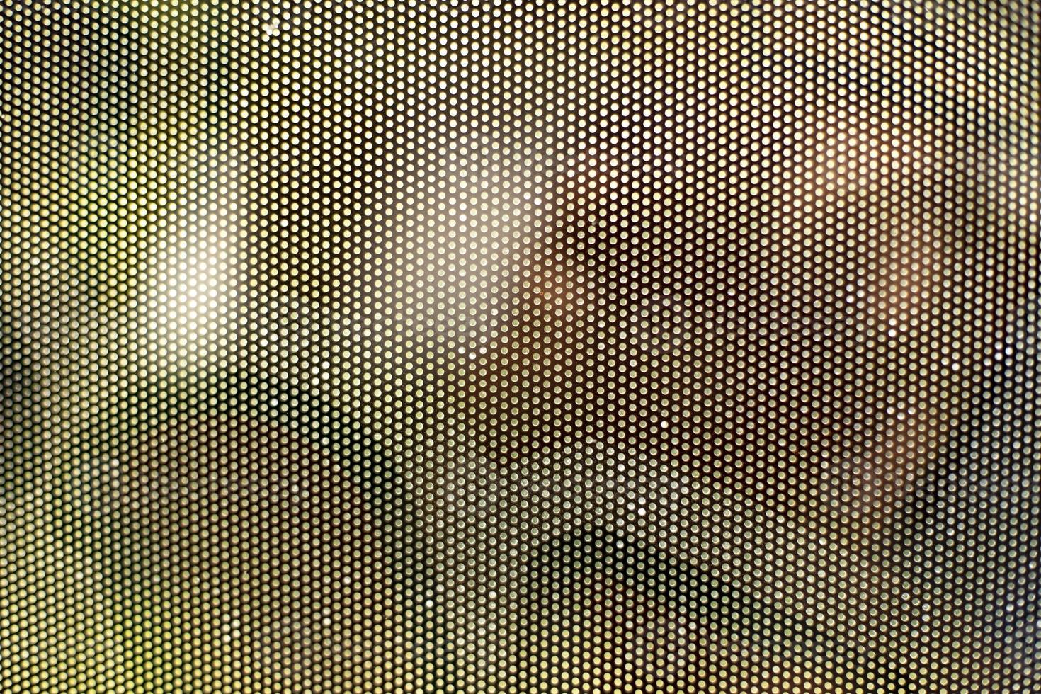 Mesh texture on glass. Shooting window. Small cage. photo