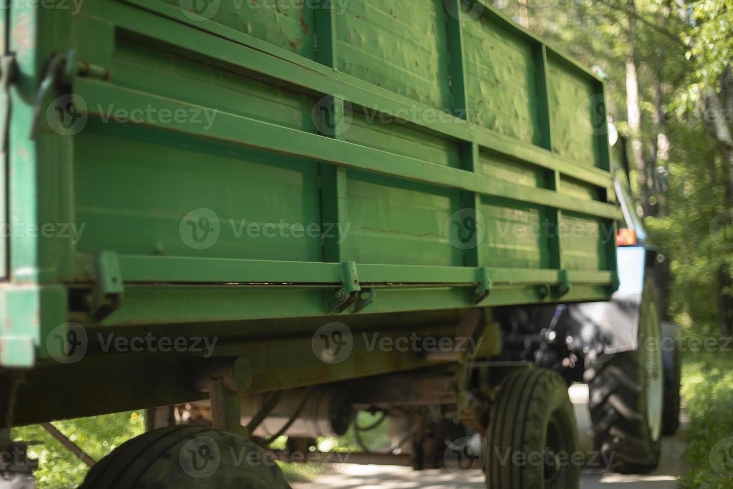 Green tractor trailer. Cart on wheels. Side of trailer. Body of transport. photo