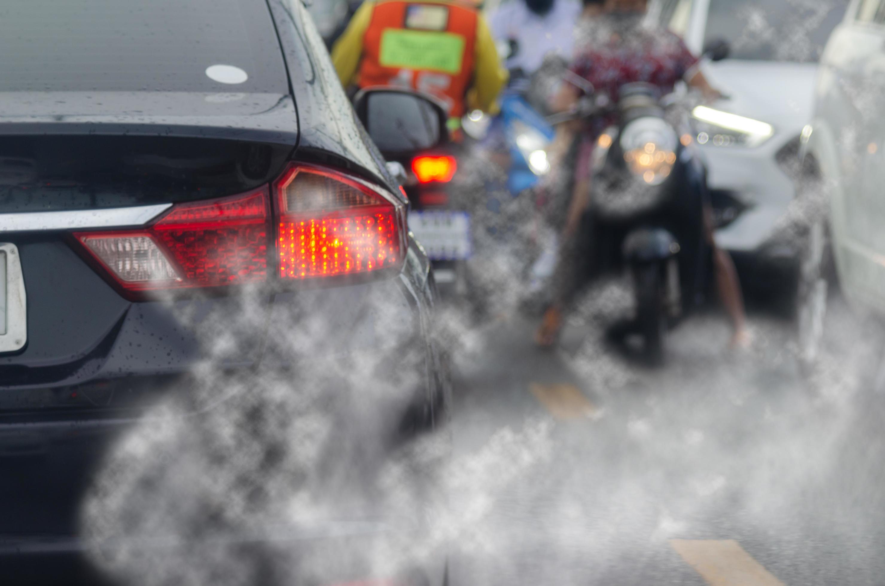 Smoke pollution from car exhaust pipes, traffic jams on the roads at