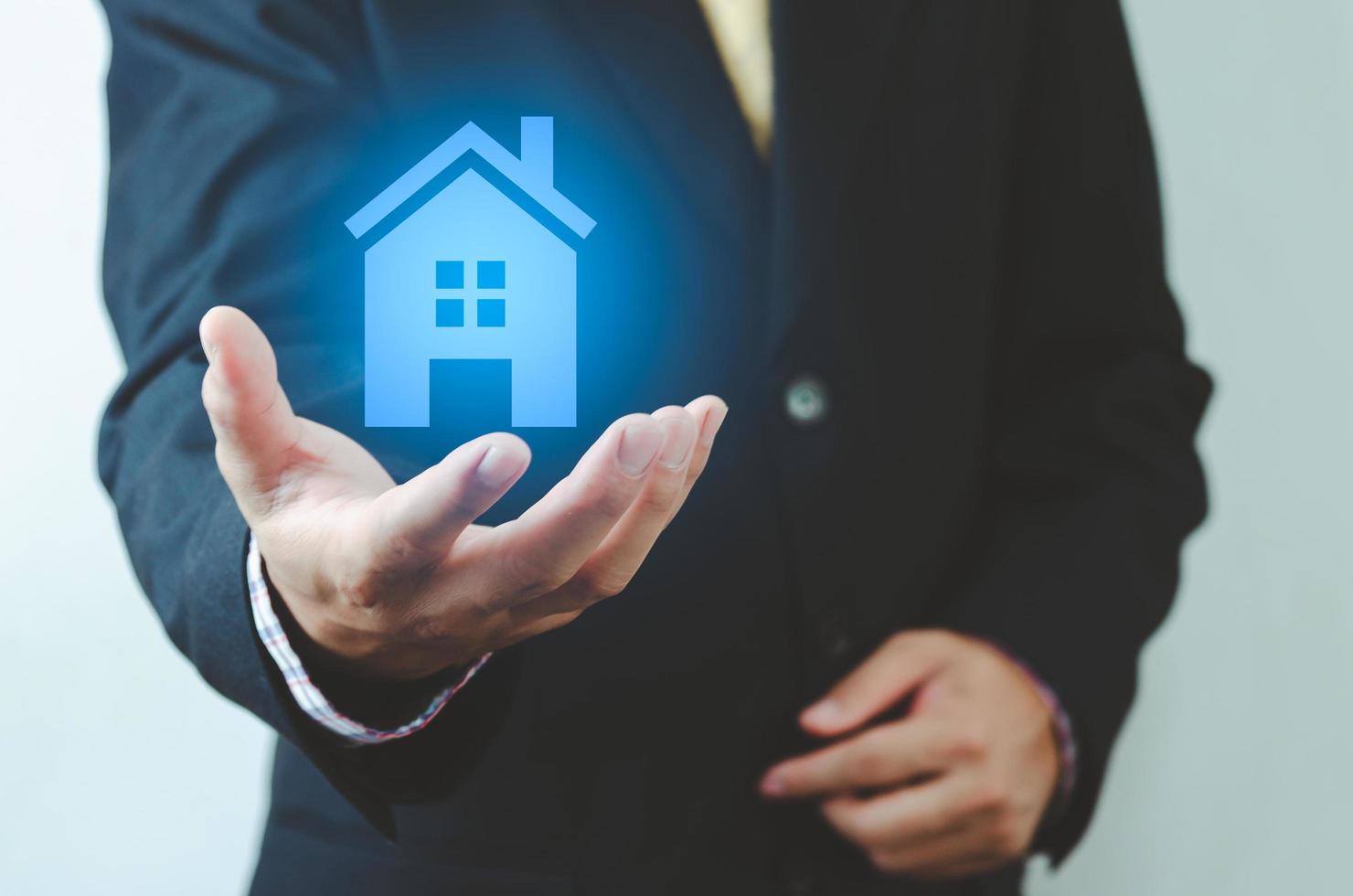 real estate ideas house trading Businessman holding house icon. House on hand. Insurance and safety concept. Symbol of house. photo