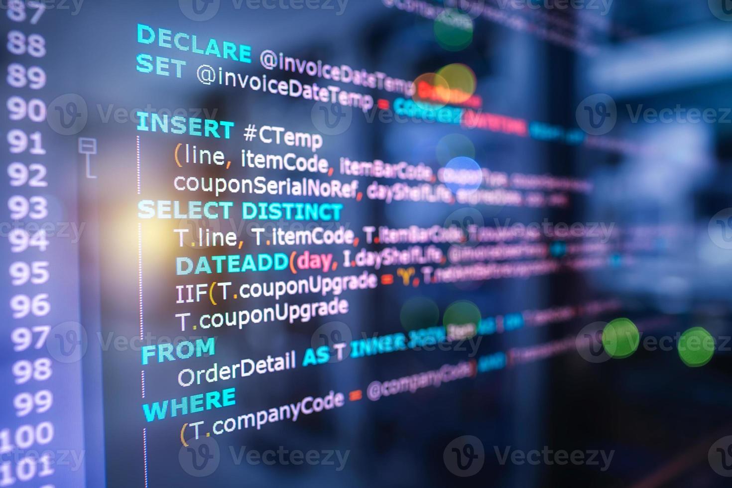SQL Structured Query Language code on computer monitor and server room background. Example of SQL code to query data from a database. photo