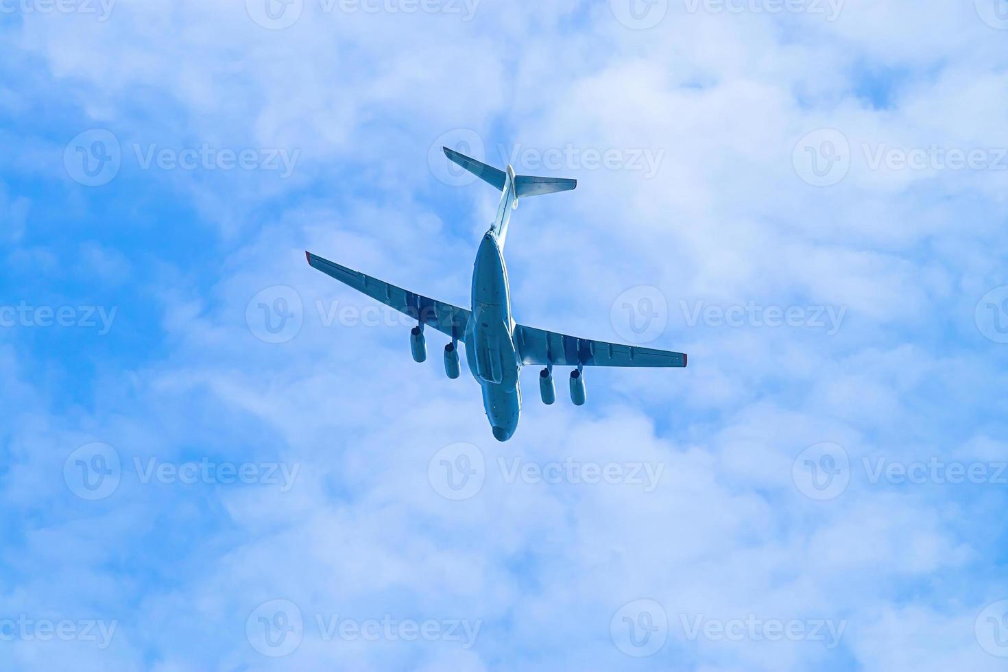 Airplane is flying in blue sky. Commercial passenger and cargo a photo