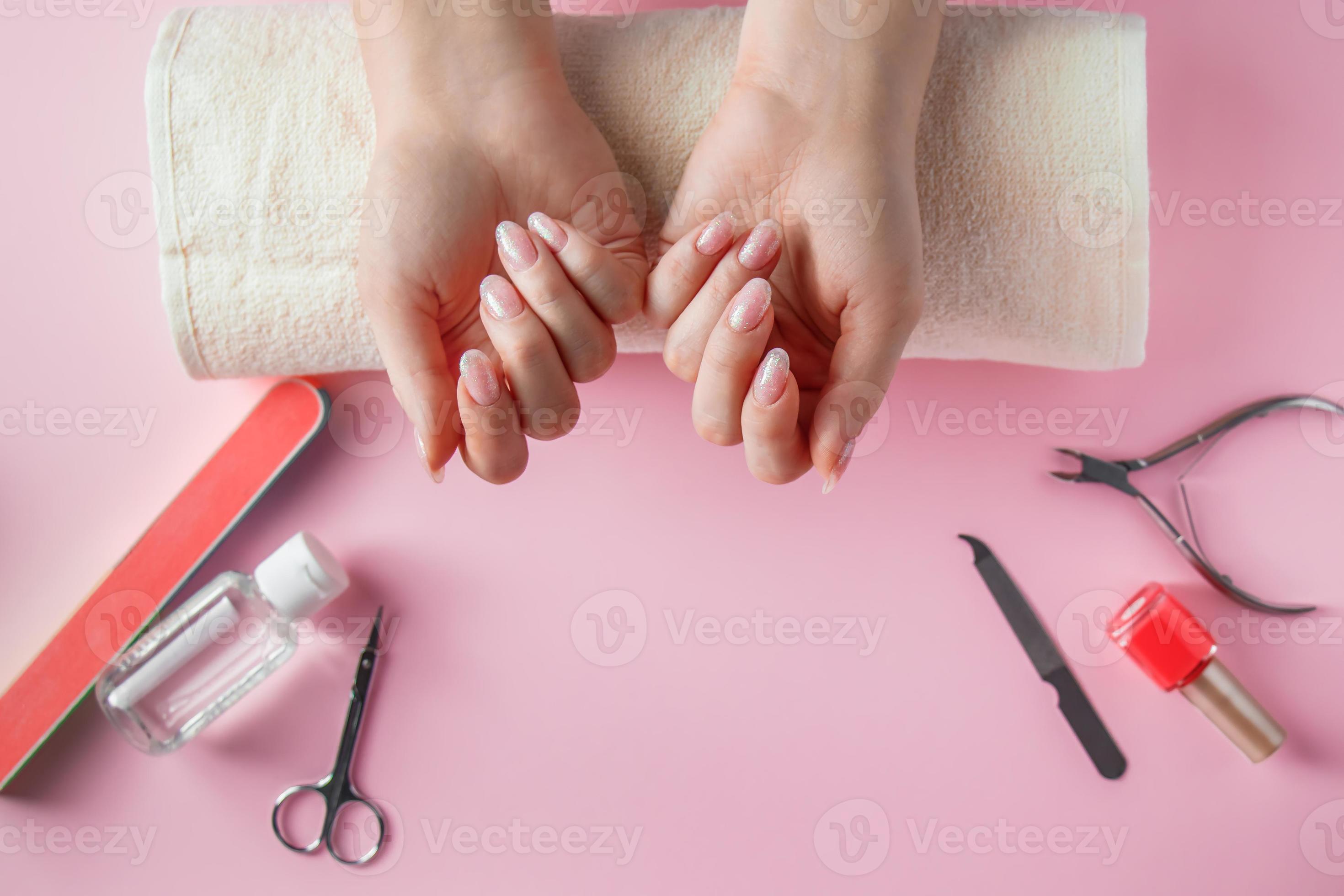 Spa procedure for nail care in a beauty salon. Female hands and tools