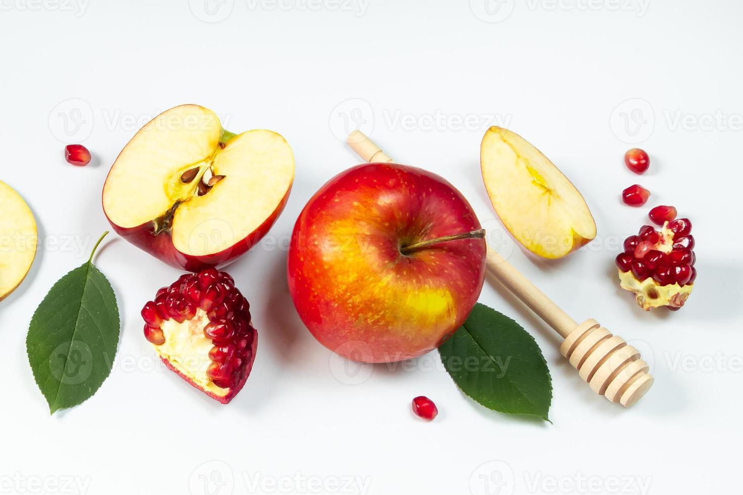 Rosh Hashanah concept. Traditional religious Jewish holiday New Year. Pomegranates, honey and apples on white background. photo