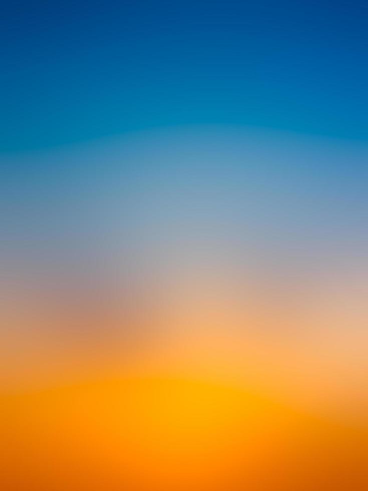 Abstract gradient sunrise in the sky with blue and orange natural background. photo