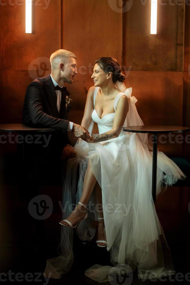 bride and groom inside a cocktail bar photo