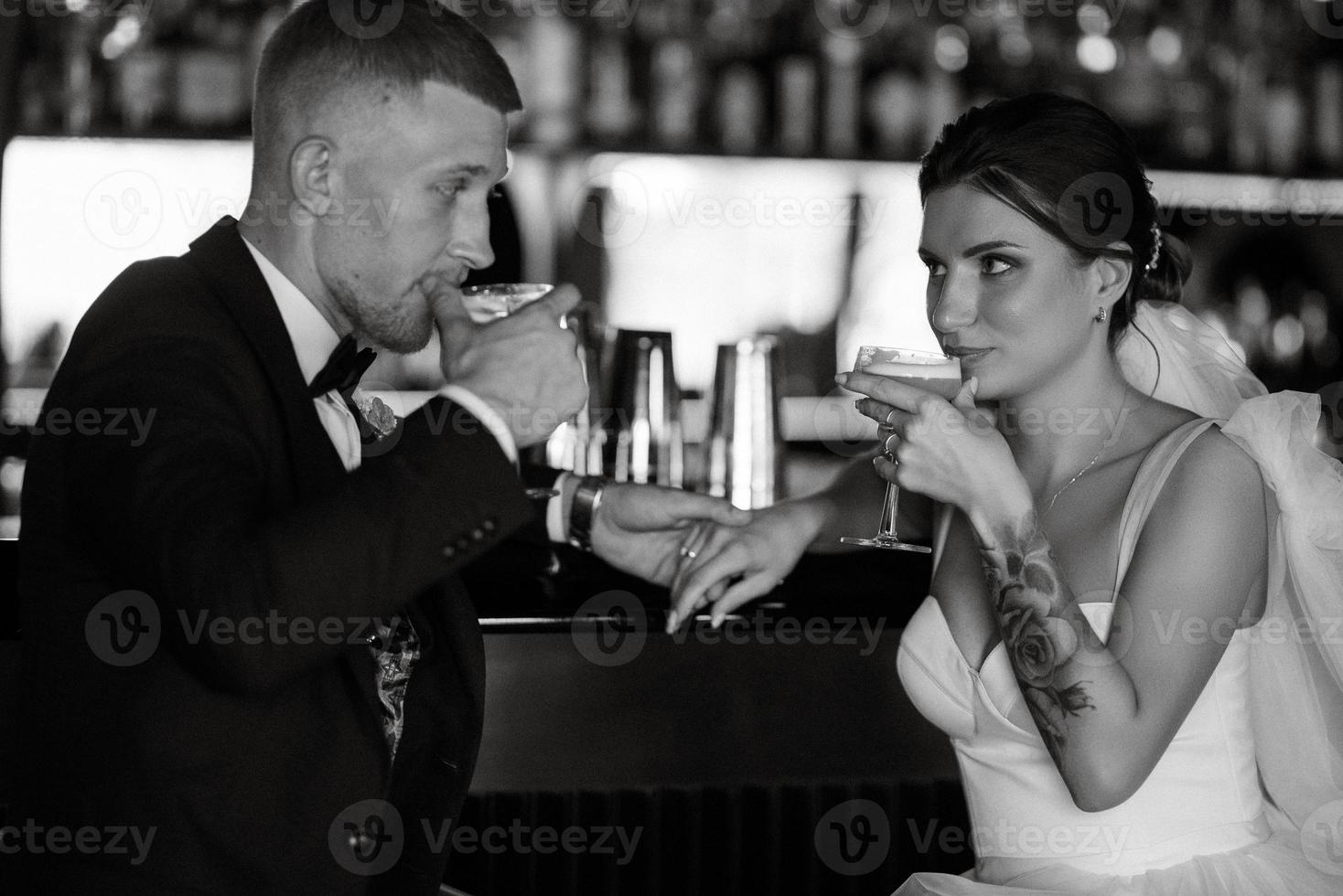 bride and groom inside a cocktail bar photo