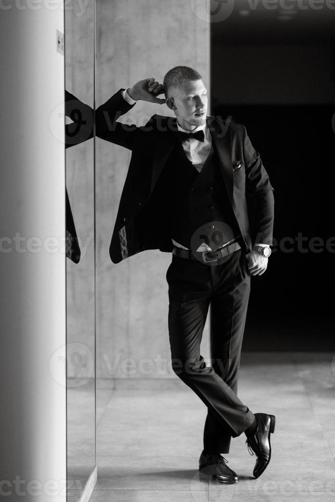 portrait of the groom in a brown three-piece suit photo