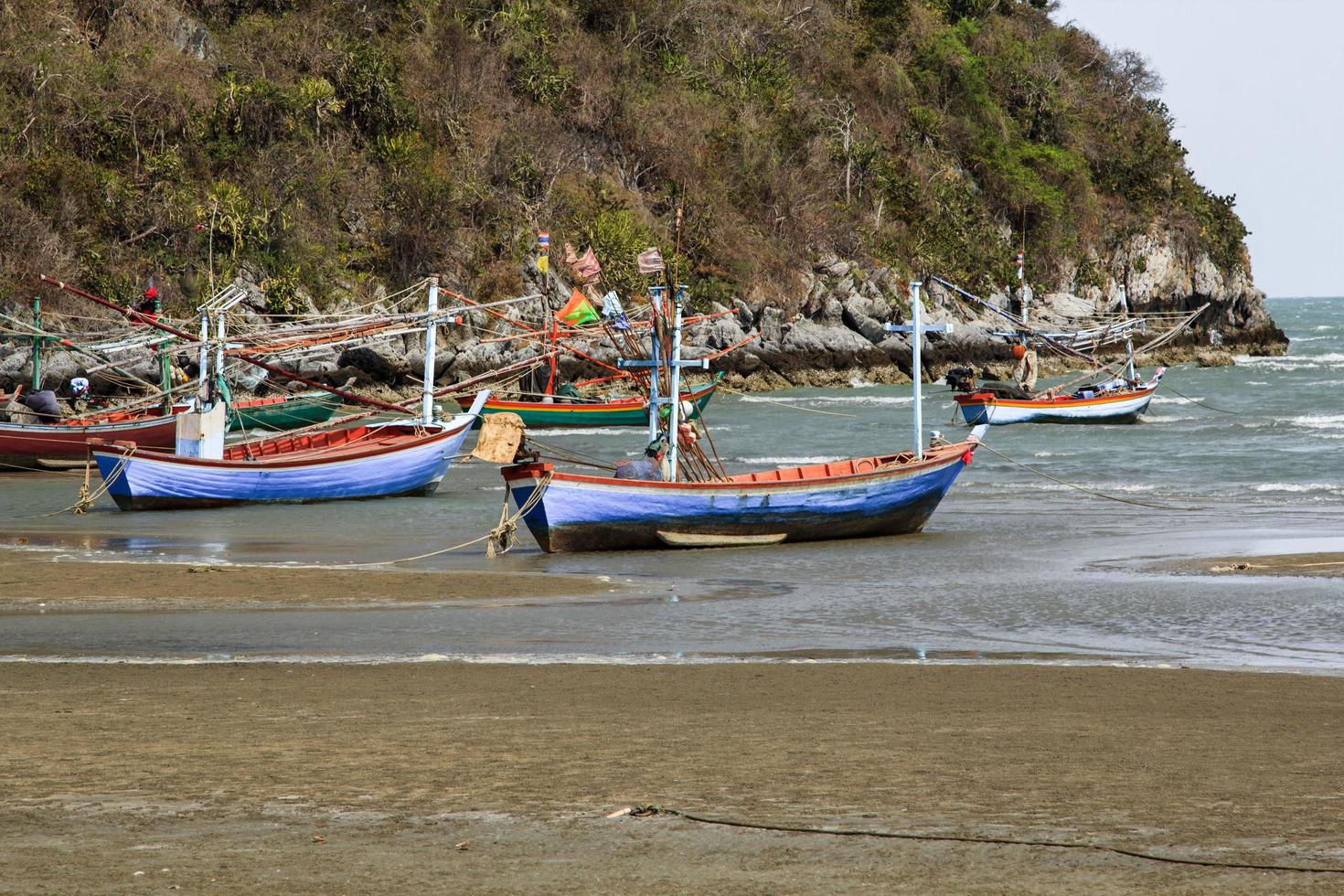 small fishing boat that catches fish and squid along the coast in a traditional way and maintains an ecosystem of fish and marine life for a long time on strong and windy days. photo