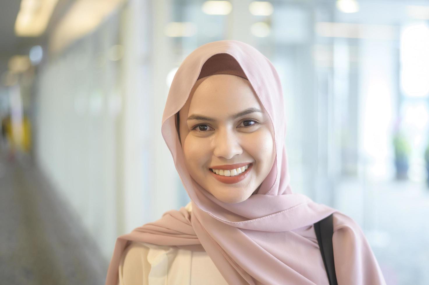 Young female muslim traveler carrying suitcases at the International ...