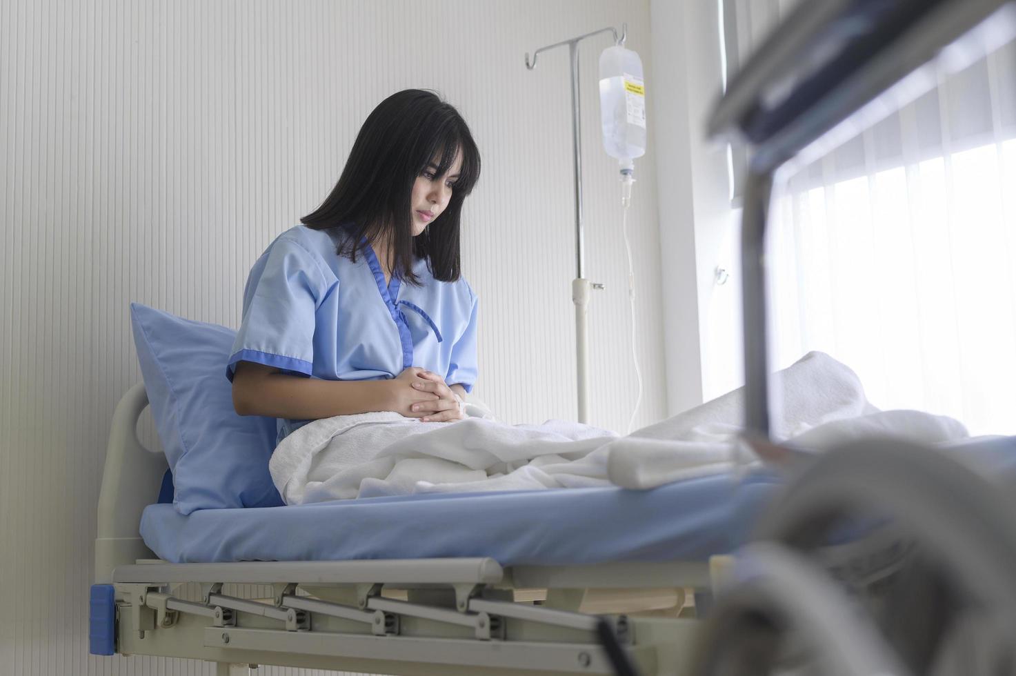 A despondent Asian woman patient. Following the doctor's declaration that the cancer was nearing the end of its course. photo