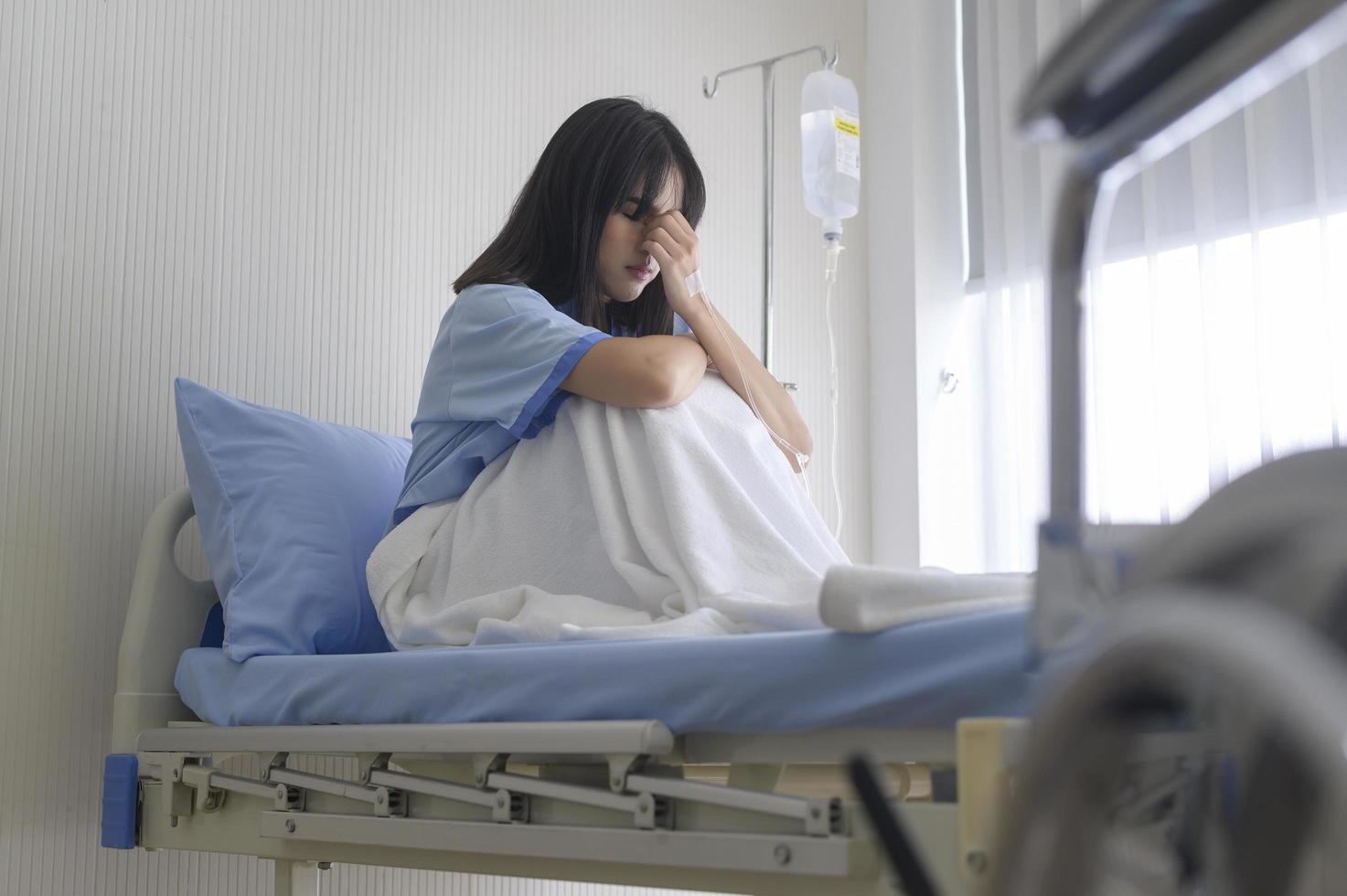 A despondent Asian woman patient. Following the doctor's declaration that the cancer was nearing the end of its course. photo