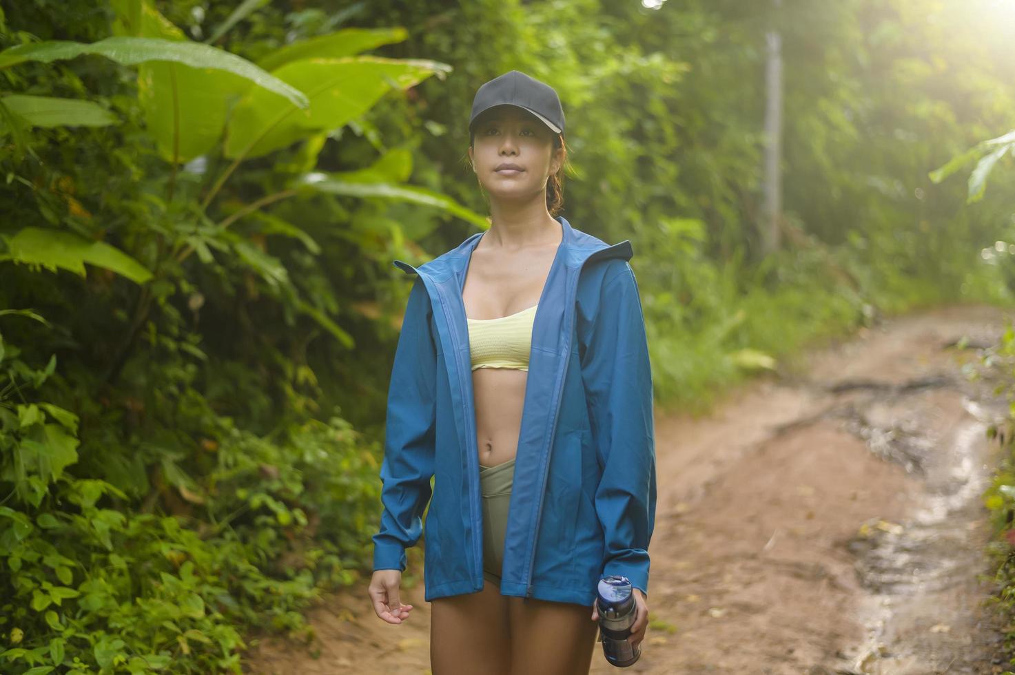 Beautiful asian woman in sportswear trekking on mountain trail, Travel and ecotourism concept. photo