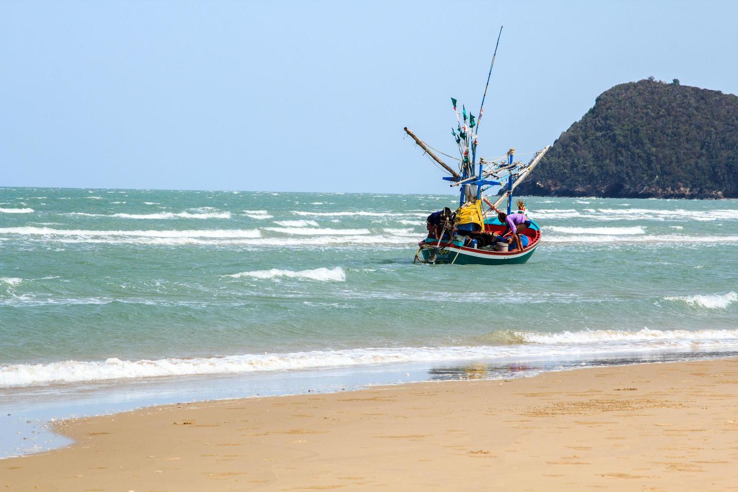 small fishing boat that catches fish and squid along the coast in a traditional way and maintains a fish and marine ecosystem for a long time on windy -Prachuap Khiri Khan -Thailand - 5 - 6 - 2016- photo