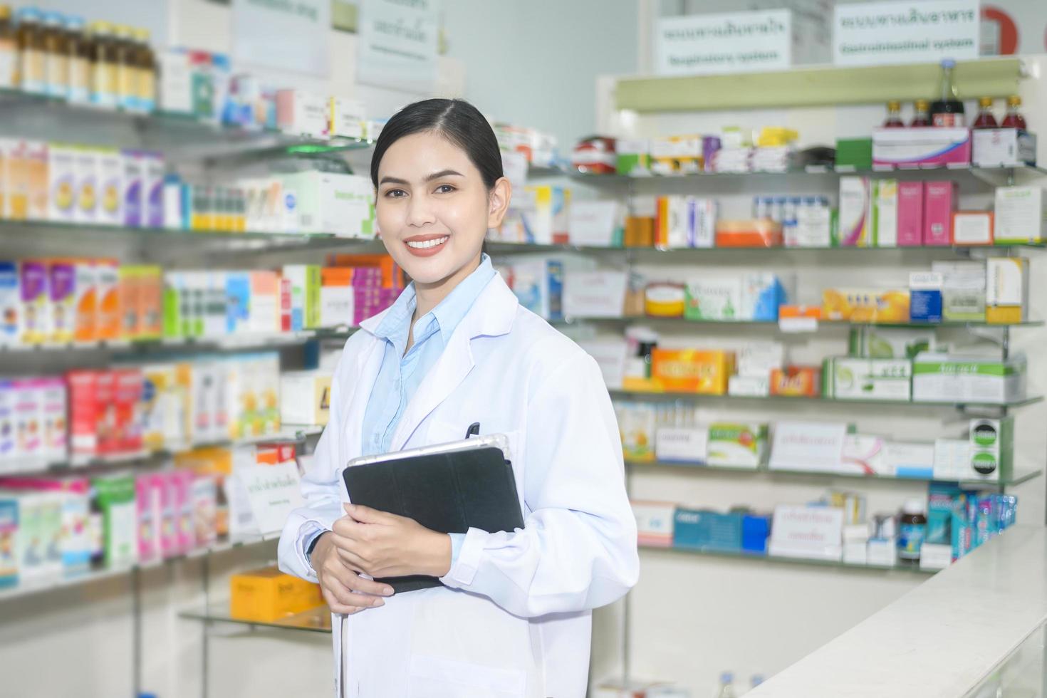 retrato de una farmacéutica que usa una tableta en una farmacia moderna. foto