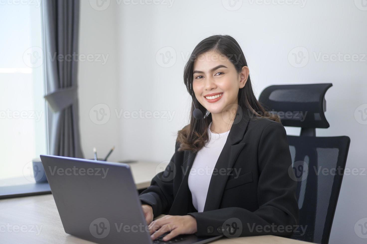 Female call center agent with headset consulting clients online, customer service and customer support operator concept photo
