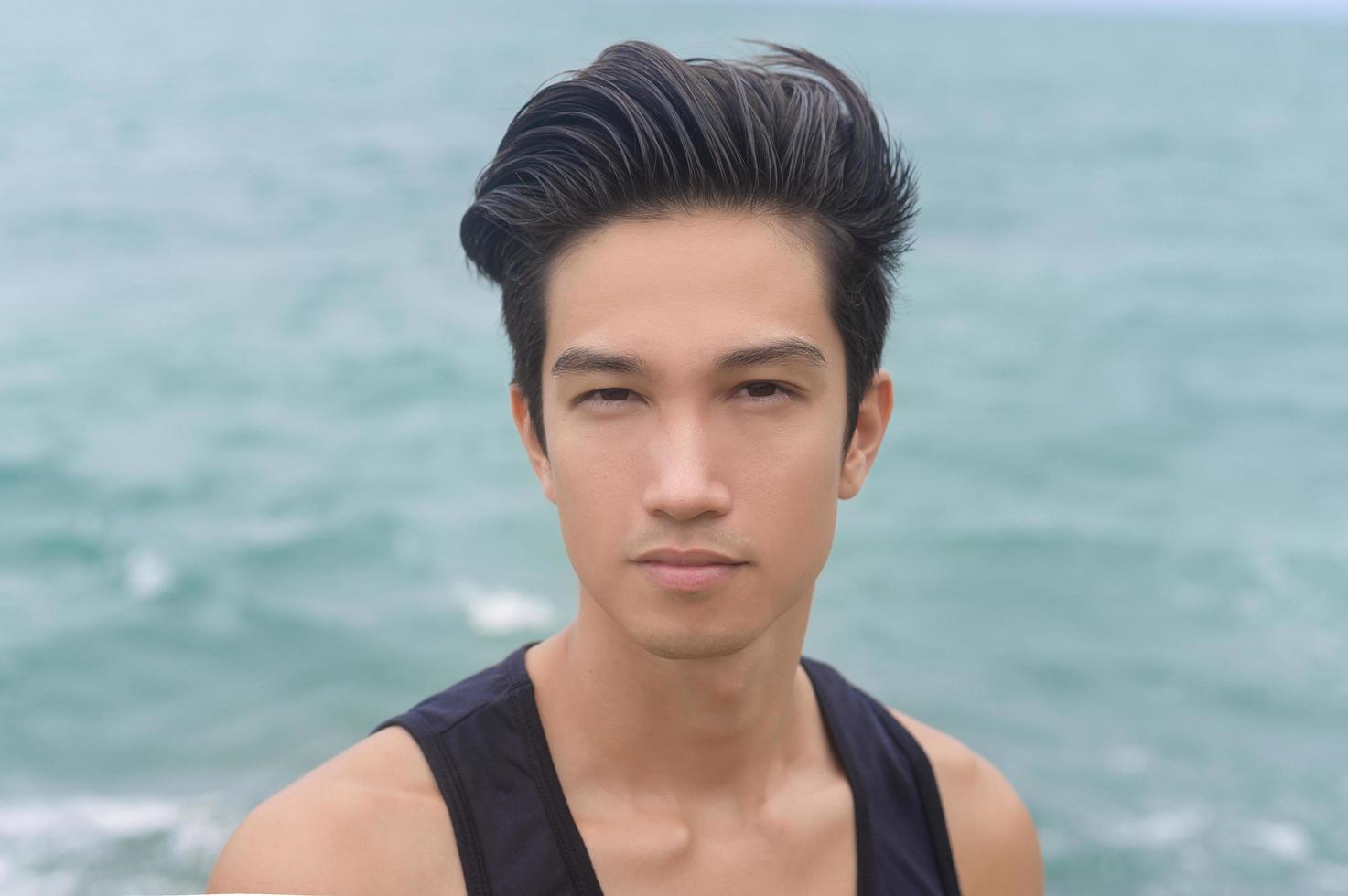 Portrait of smiling male tourist on the seaside, nature tourism concept photo