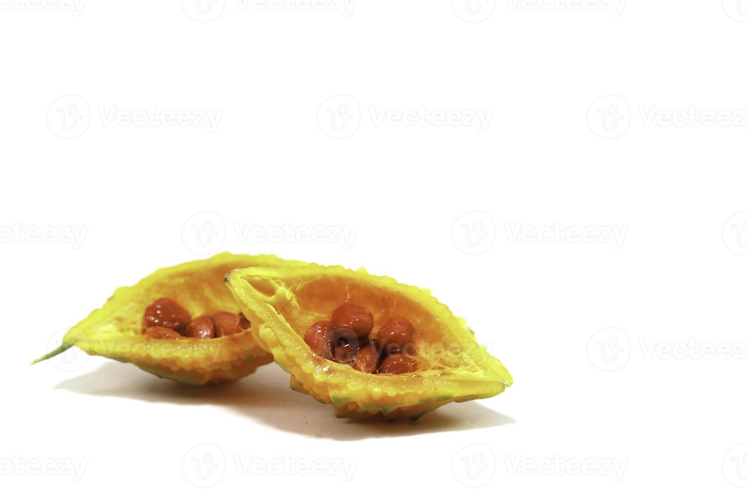 Yellow rough-skinned bitter gourd is ripe, edible and herbal, with a bitter taste on a white background. photo