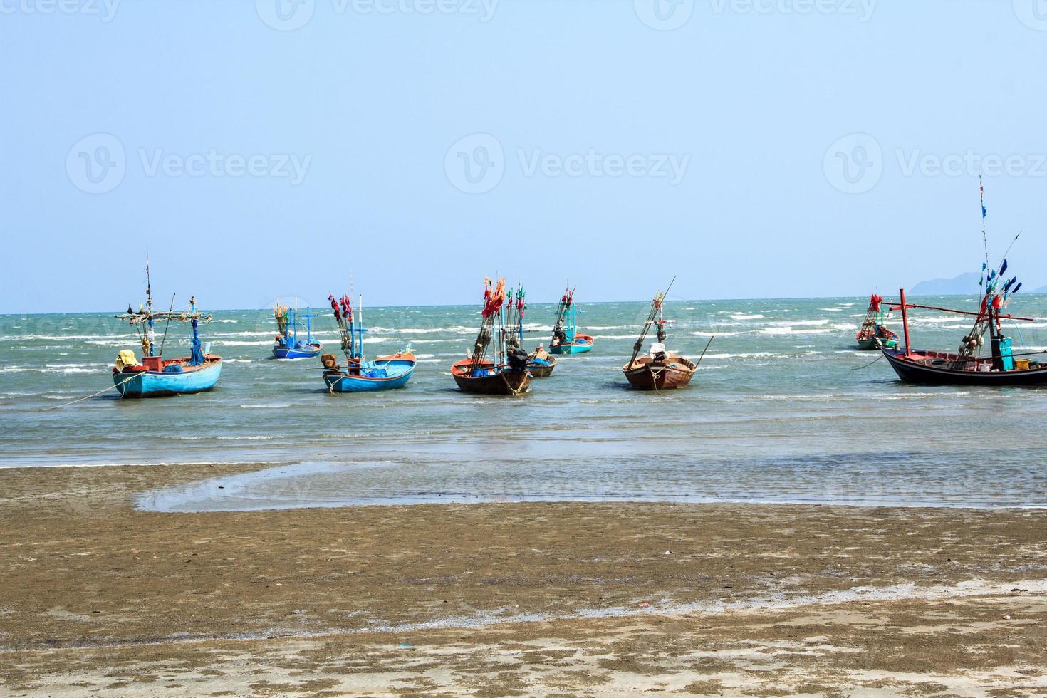 small fishing boat that catches fish and squid along the coast in a traditional way and maintains a fish and marine ecosystem for a long time on windy days photo