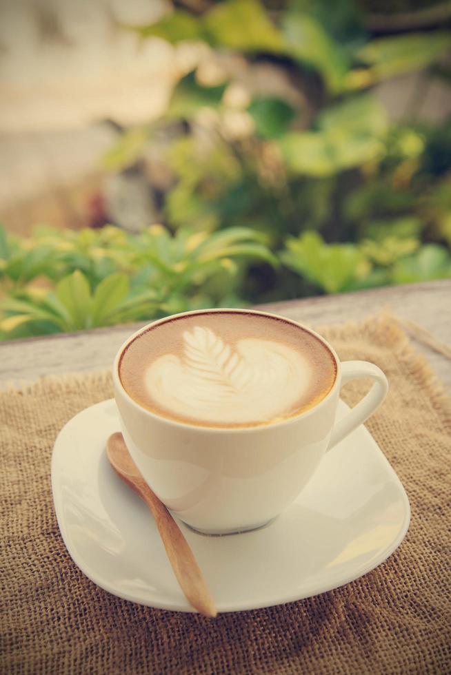 Coffee cup in coffee shop with vintage filter effect photo