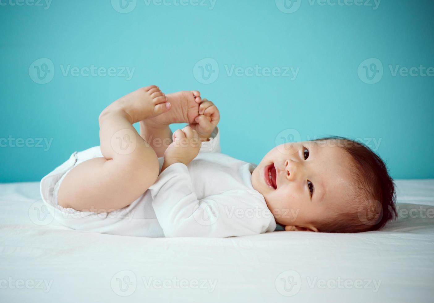 Cute asian baby girl lying on the bed, Healthy child with new family concept photo