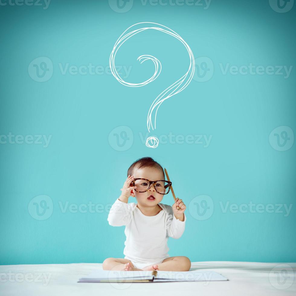 Asian baby with her imagination about future concept, hand drawn on the green background, education back to school photo