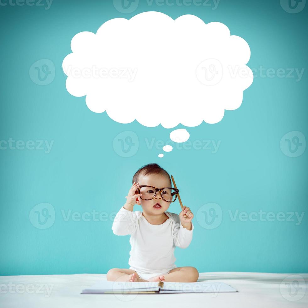 Asian baby with her imagination about future concept, hand drawn on the green background, education back to school photo