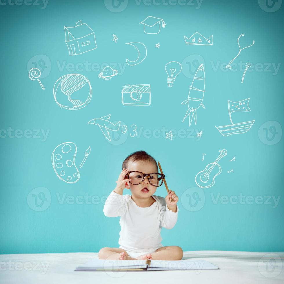 Asian baby with her imagination about science and space adventure, hand drawn on the green background, education back to school and future concept photo