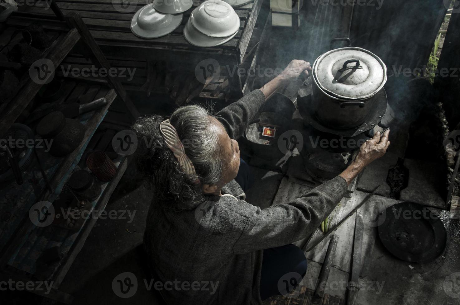 Asian grandmother cooking at home photo