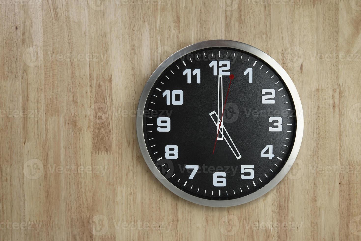 Standless Clock at 5 O'Clock, Finish work at 5 PM. Isolate on wooden Background, photo