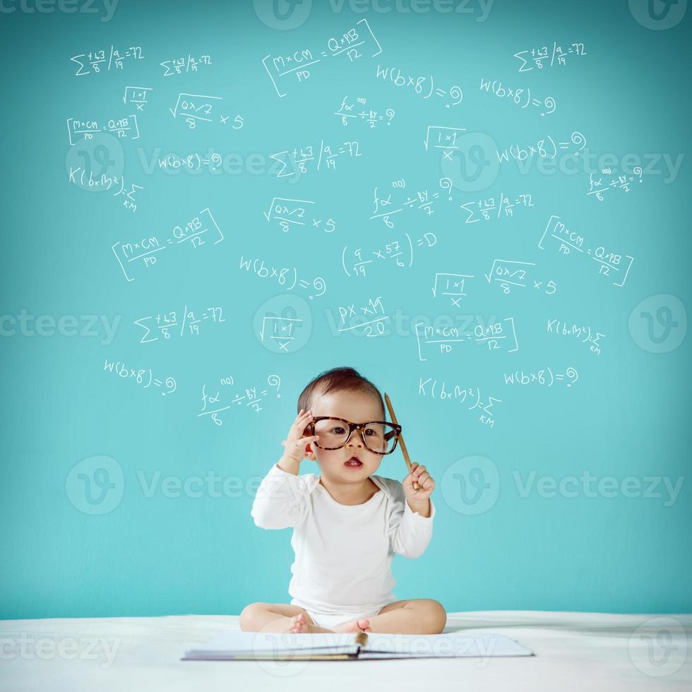 Asian baby with her imagination about science and space adventure, hand drawn on the green background, education back to school and future concept photo