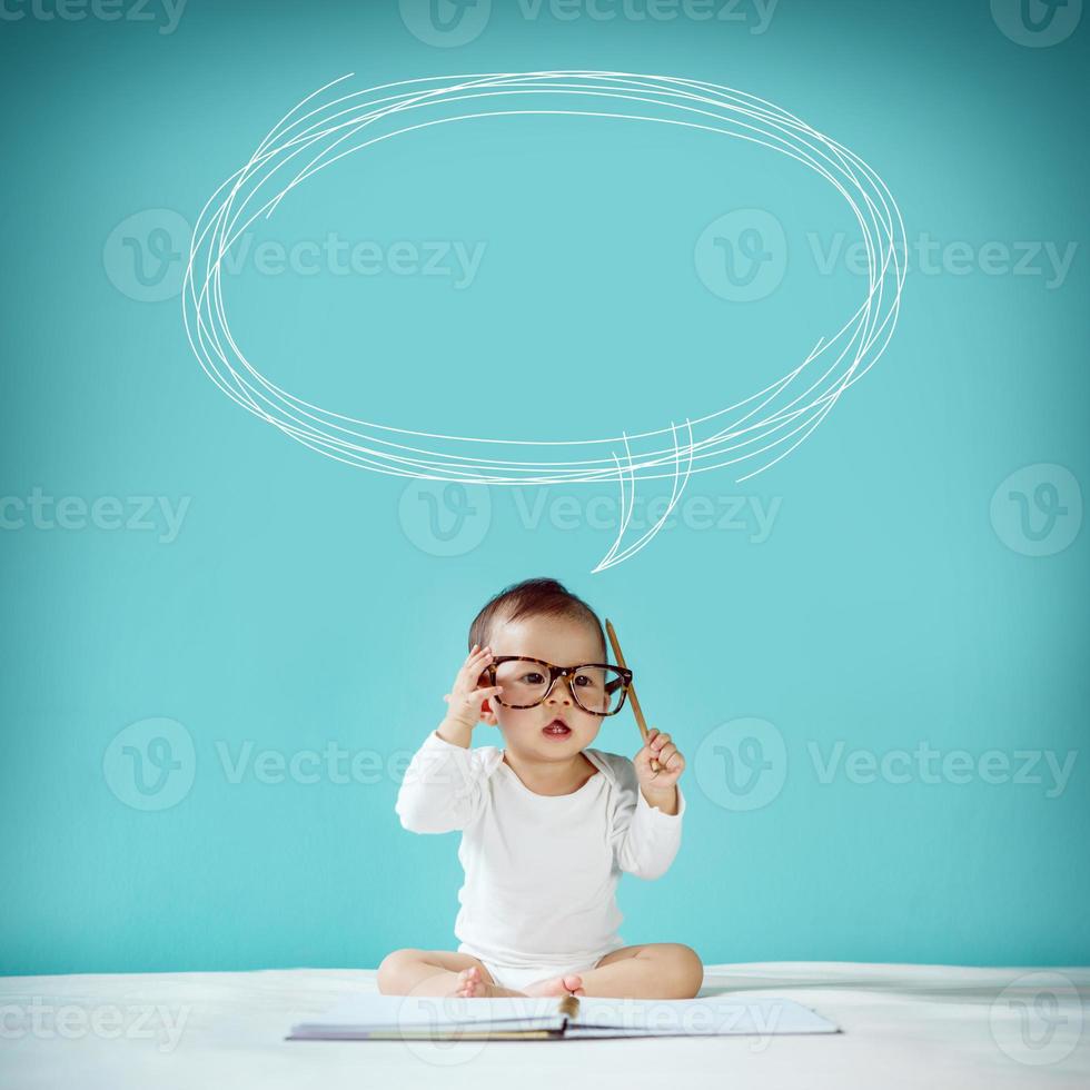 Asian baby with her imagination about future concept, hand drawn on the green background, education back to school photo