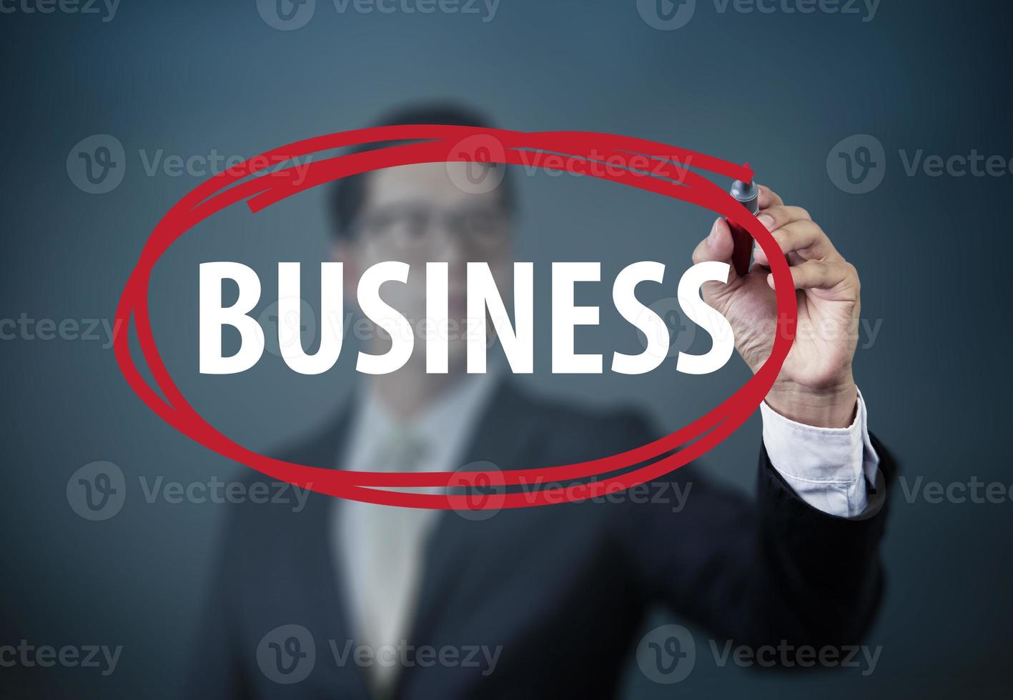 Businessman hand writing Business with red marker on transparent board, new business concept, studio shot photo