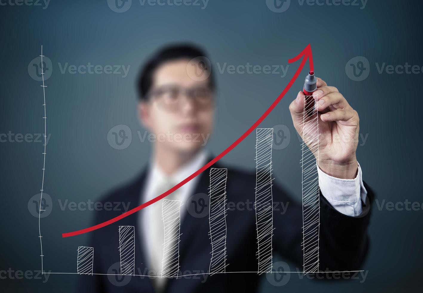 Businessman hand writing graph of growth, new business concept, studio shot photo