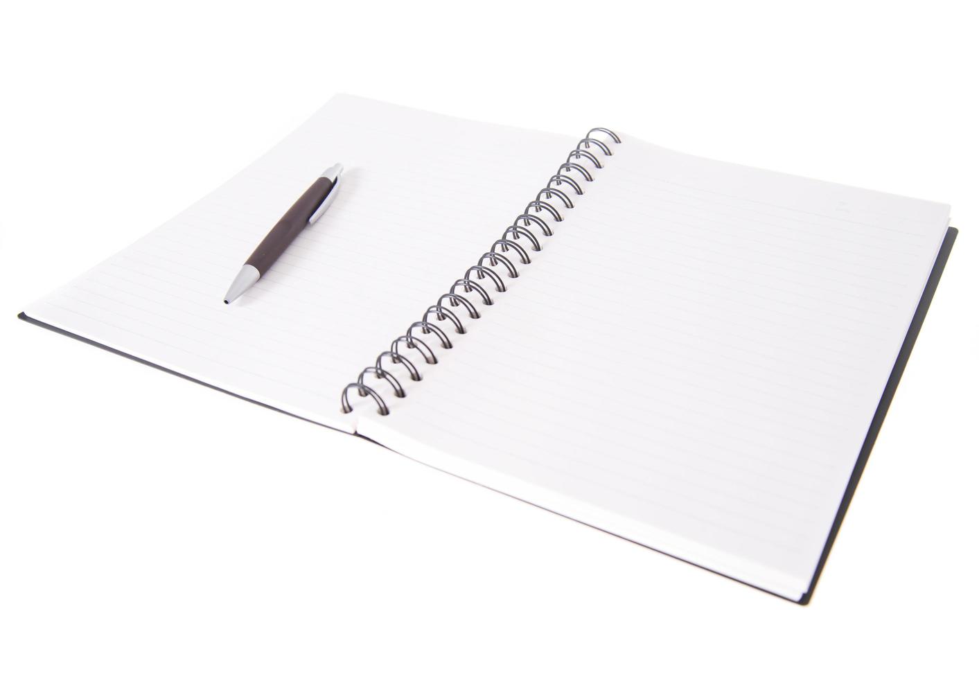 Blank open notebook lined papers with pen photo