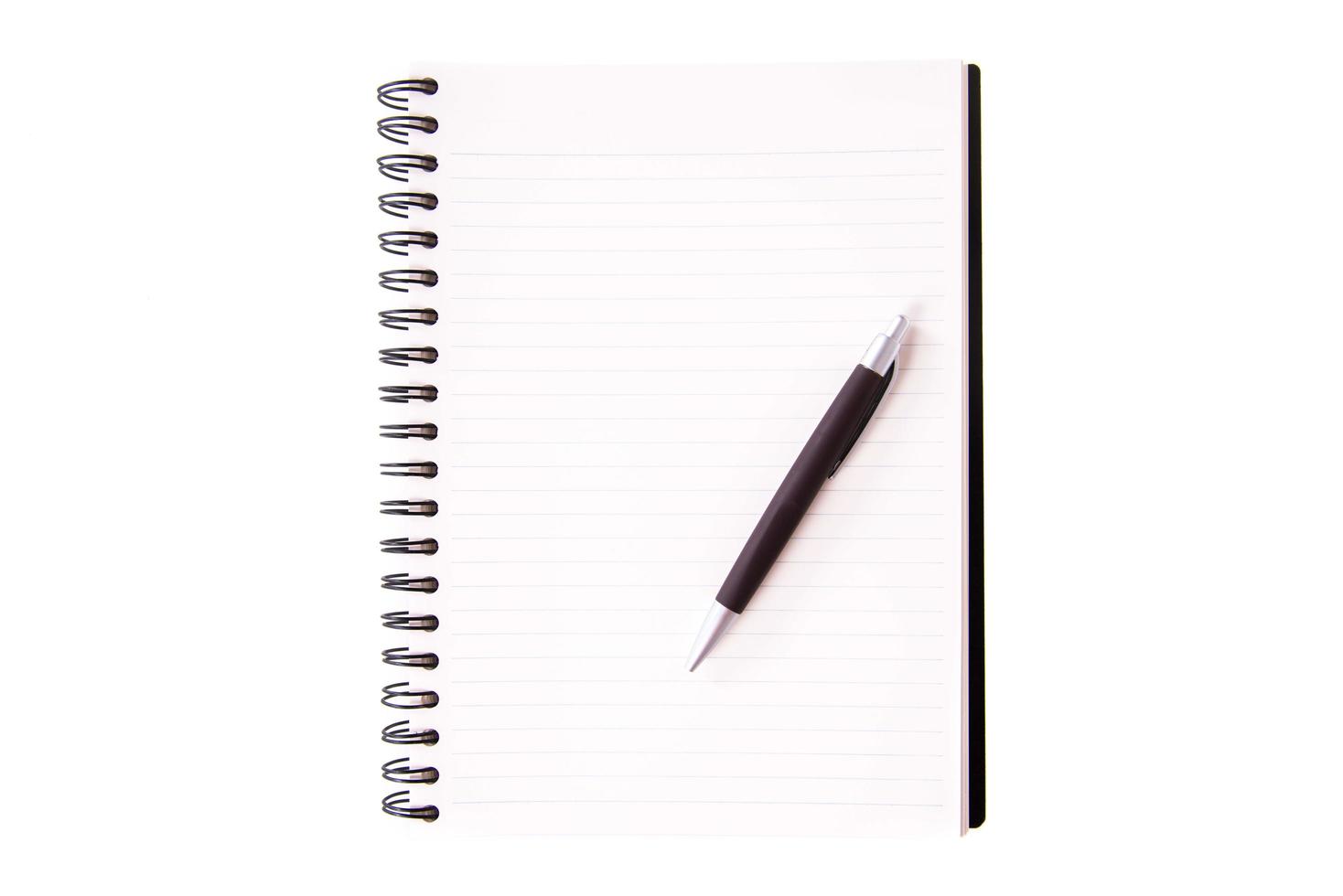 Blank open notebook lined papers with pen photo