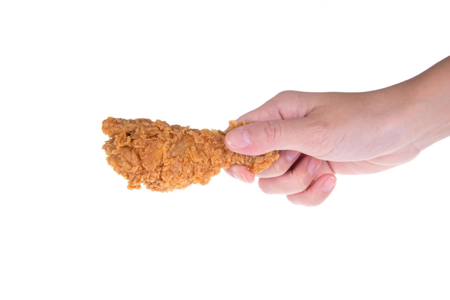 Hand hold fried chicken isolated on white photo