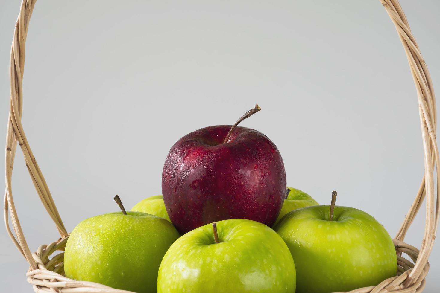 Fresh colorful apple over gray background - clean fresh fruit background concept photo